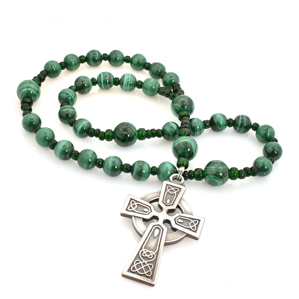 A string of round green beads with a silver Celtic Aura cross pendant at the center.
